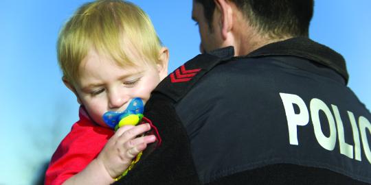 Officer carries toddler