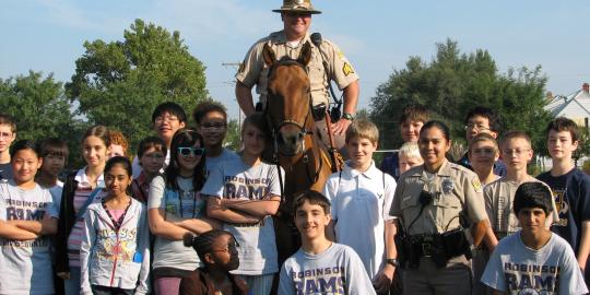 Officer on horse with smiling children