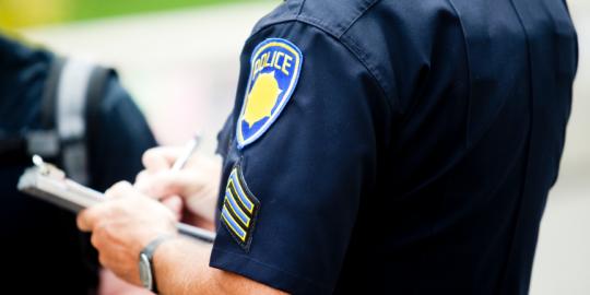 Police officer writing a report
